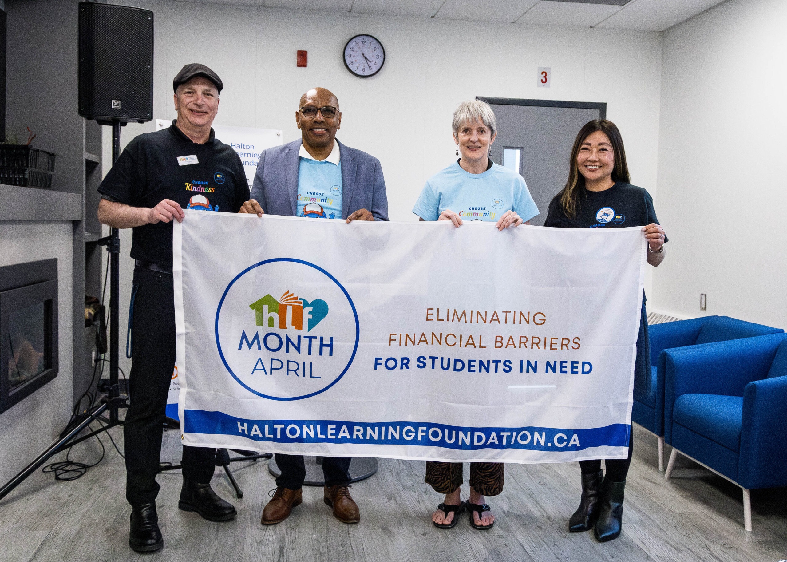the image shows HDSB and HLF leadership team carrying a flag to launch HLF Month to help students in need.