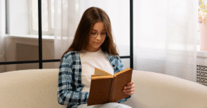 Visual showing a young girl reading a book