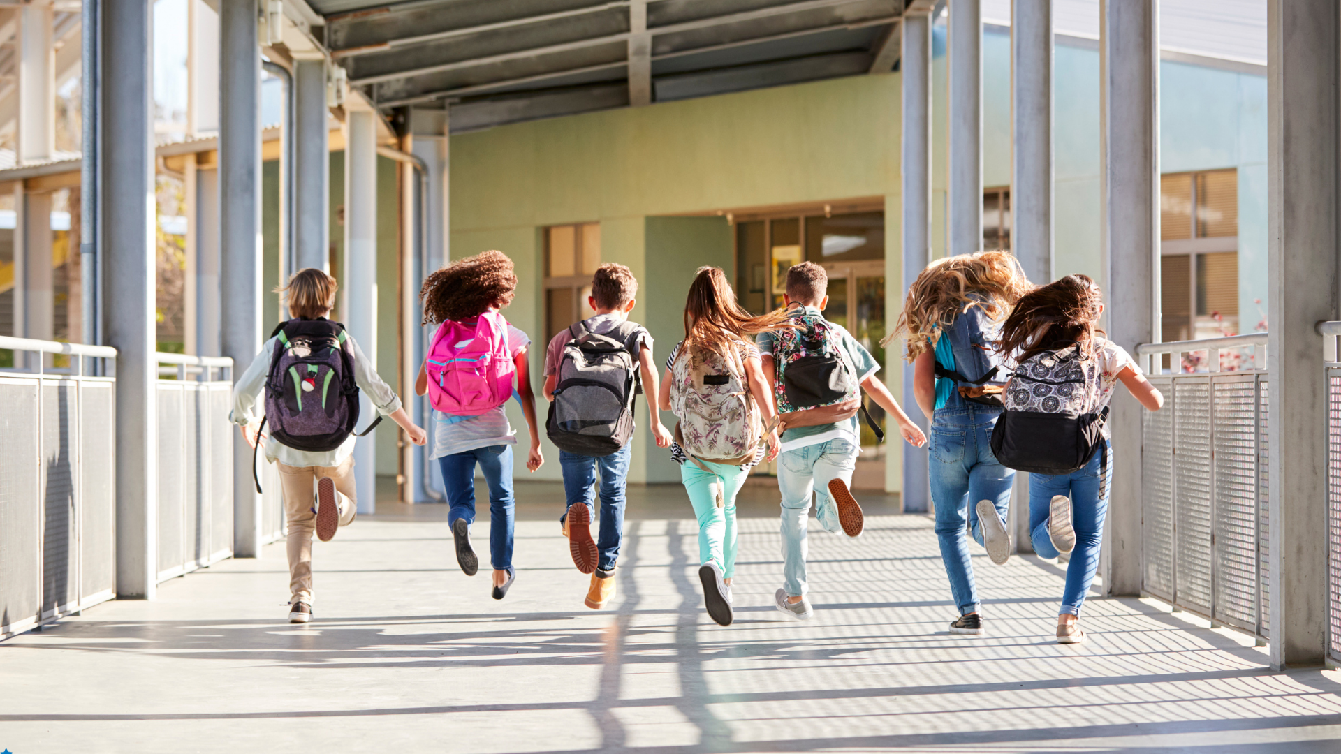 Visual showing students actively running back to school with their backpacks.
